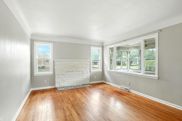 2707 Byron Center Ave SW, Wyoming, MI 49519 - unfurnished living room with wood-type flooring and a stone fireplace