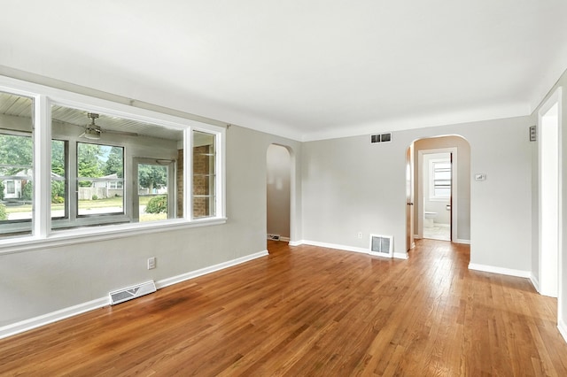 2707 Byron Center Ave SW, Wyoming, MI 49519 - empty room featuring arched walkways, wood-type flooring, and a ceiling fan