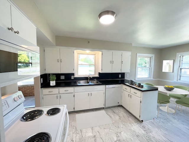 2707 Byron Center Ave SW, Wyoming, MI 49519 - kitchen with white appliances, dark countertops, white cabinetry, a peninsula, and light marble finish floors