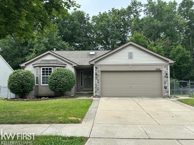 3242 Herrington Dr, Holly, MI 48442 - ranch-style home with stone siding, concrete driveway, and an attached garage