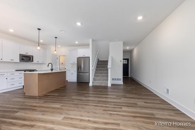 3351 Kings River St SW Unit 35, Wyoming, MI 49418 - kitchen with stainless steel appliances, open floor plan, white cabinets, wood finished floors, and recessed lighting