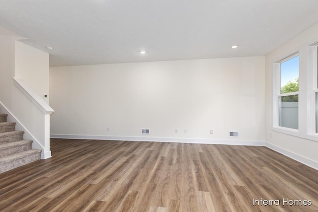 3351 Kings River St SW Unit 35, Wyoming, MI 49418 - unfurnished living room featuring wood finished floors, stairs, and recessed lighting
