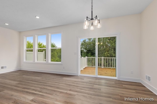 3351 Kings River St SW Unit 35, Wyoming, MI 49418 - unfurnished room with healthy amount of natural light, a chandelier, wood finished floors, and recessed lighting
