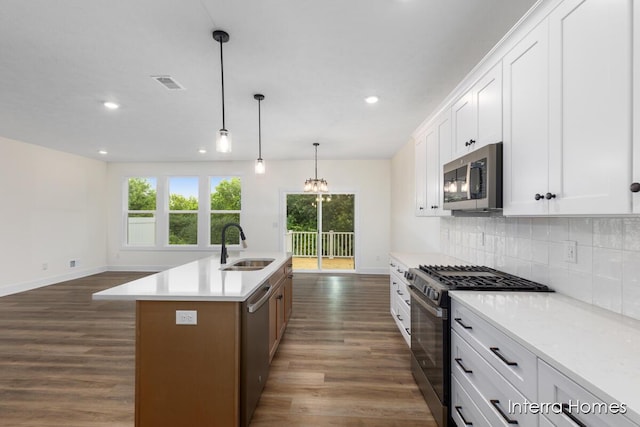 3351 Kings River St SW Unit 35, Wyoming, MI 49418 - kitchen with stainless steel appliances, dark wood-type flooring, recessed lighting, tasteful backsplash, and a center island with sink