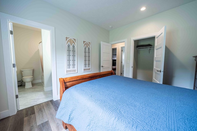 7898 W Juniper Beach Rd, Mears, MI 49436 - bedroom featuring dark wood-style flooring, connected bathroom, and recessed lighting