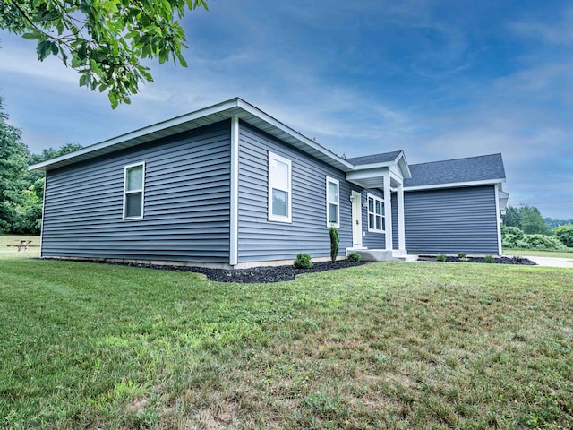 7898 W Juniper Beach Rd, Mears, MI 49436 - view of home's exterior featuring a lawn