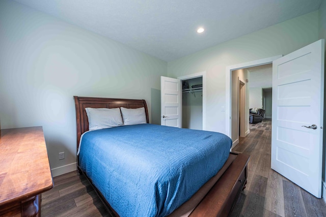 7898 W Juniper Beach Rd, Mears, MI 49436 - bedroom with dark wood-style floors, recessed lighting, and a closet