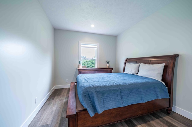7898 W Juniper Beach Rd, Mears, MI 49436 - bedroom with wood finished floors, a textured ceiling, and recessed lighting