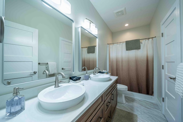 7898 W Juniper Beach Rd, Mears, MI 49436 - bathroom featuring double vanity, recessed lighting, and a shower with shower curtain