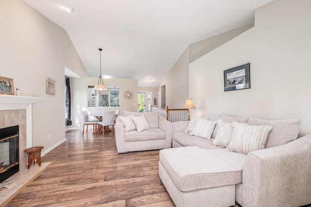 5766 Wineberry Ln SW, Wyoming, MI 49418 - living area featuring wood finished floors, lofted ceiling, and a tile fireplace