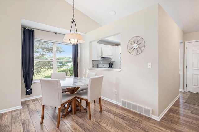 5766 Wineberry Ln SW, Wyoming, MI 49418 - dining space featuring wood finished floors and vaulted ceiling