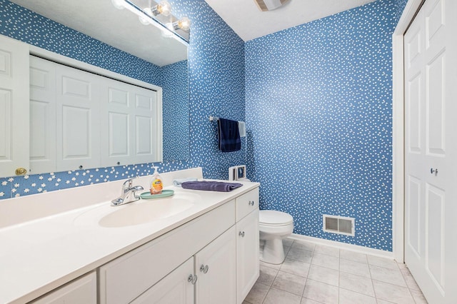 5766 Wineberry Ln SW, Wyoming, MI 49418 - bathroom with wallpapered walls, vanity, and tile patterned floors