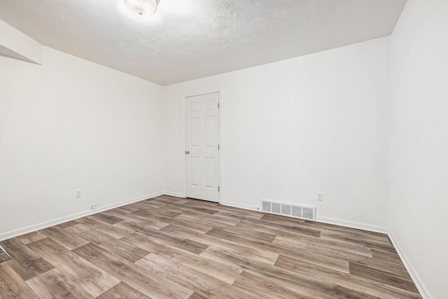 5766 Wineberry Ln SW, Wyoming, MI 49418 - empty room with light wood-style flooring and a textured ceiling