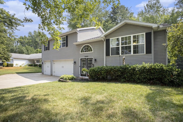 12912 Valley Dr, Wayland, MI 49348 - view of front of house featuring an attached garage, concrete driveway, and a front lawn