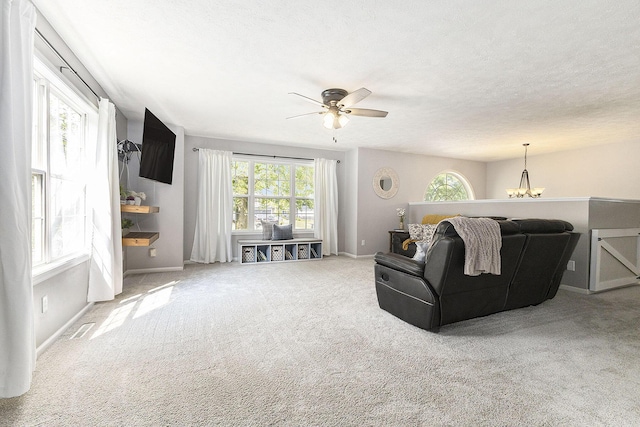 12912 Valley Dr, Wayland, MI 49348 - carpeted living room featuring healthy amount of natural light, a ceiling fan, and a chandelier