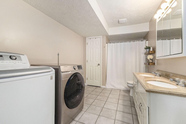 12912 Valley Dr, Wayland, MI 49348 - laundry area with separate washer and dryer, light tile patterned flooring, and a textured ceiling