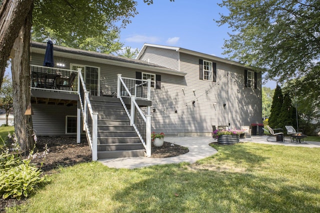 12912 Valley Dr, Wayland, MI 49348 - rear view of house with stairway, a yard, a wooden deck, an outdoor fire pit, and a patio