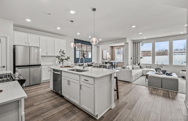 4066 Nottingham Cir, Clarkston, MI 48346 - kitchen with appliances with stainless steel finishes, open floor plan, recessed lighting, light countertops, and wood finished floors