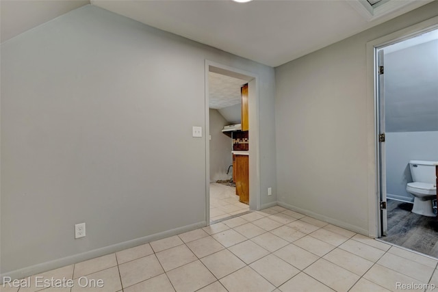 1425 Lincoln Ave, Flint, MI 48507 - spare room with vaulted ceiling and light tile patterned floors