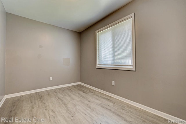 1425 Lincoln Ave, Flint, MI 48507 - spare room with wood finished floors and baseboards