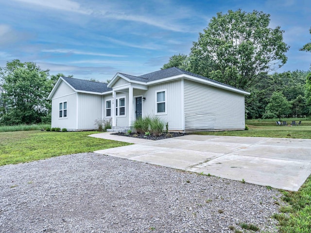 7920 W Juniper Beach Rd, Mears, MI 49436 - view of front of home featuring concrete driveway, a front lawn, and a shingled roof