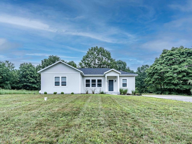 7920 W Juniper Beach Rd, Mears, MI 49436 - ranch-style house with a front lawn and roof with shingles