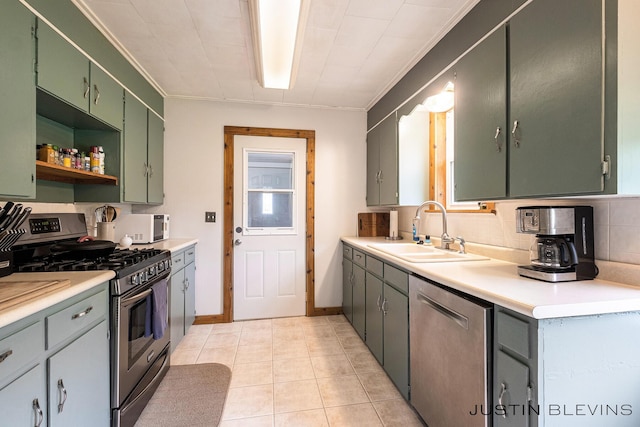 8277 Alpine Ave NW, Sparta, MI 49345 - kitchen featuring appliances with stainless steel finishes, crown molding, light countertops, light tile patterned flooring, and decorative backsplash