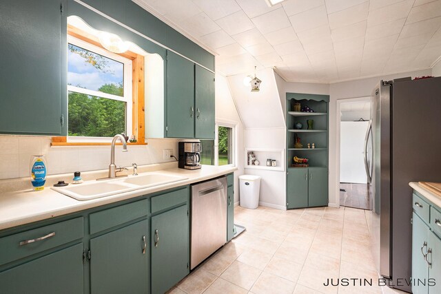 8277 Alpine Ave NW, Sparta, MI 49345 - kitchen with green cabinetry, stainless steel appliances, ornamental molding, light countertops, and light tile patterned flooring