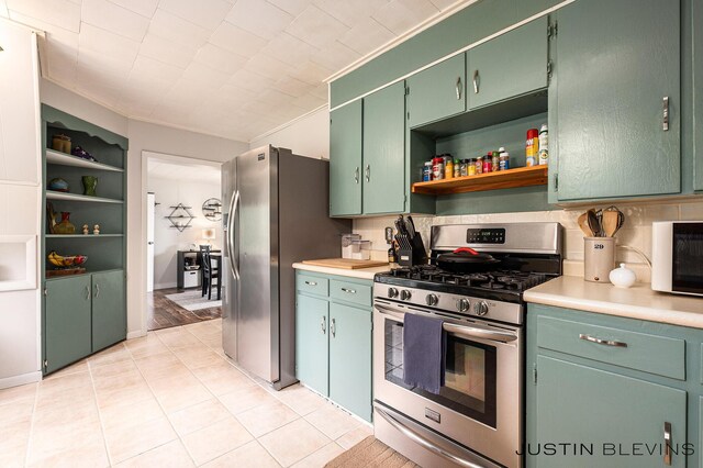 8277 Alpine Ave NW, Sparta, MI 49345 - kitchen featuring appliances with stainless steel finishes, open shelves, light countertops, and light tile patterned flooring