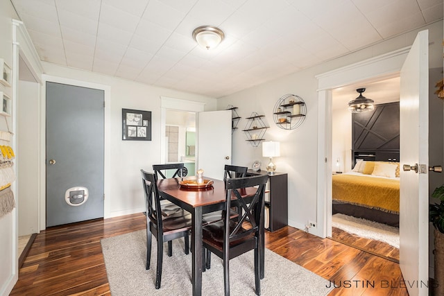 8277 Alpine Ave NW, Sparta, MI 49345 - dining space with dark wood-style flooring and baseboards