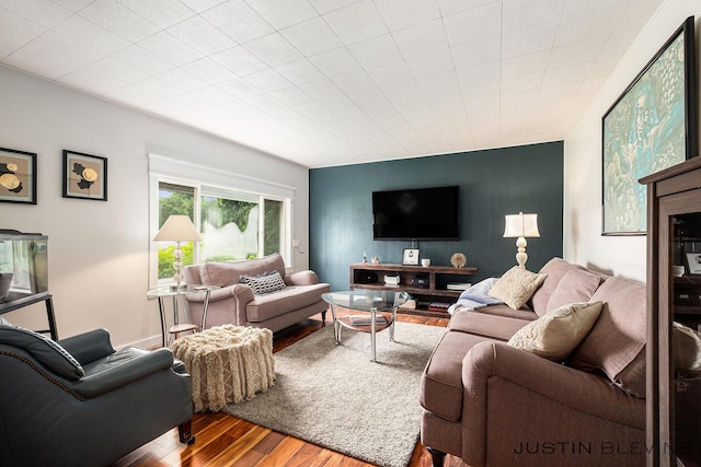 8277 Alpine Ave NW, Sparta, MI 49345 - living area featuring an accent wall and wood finished floors