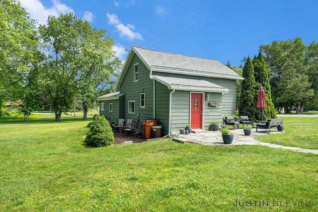 8277 Alpine Ave NW, Sparta, MI 49345 - view of front of home featuring a front yard, a patio area, and a shingled roof