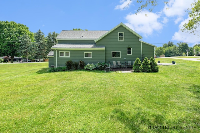 8277 Alpine Ave NW, Sparta, MI 49345 - rear view of house featuring a lawn and a shingled roof