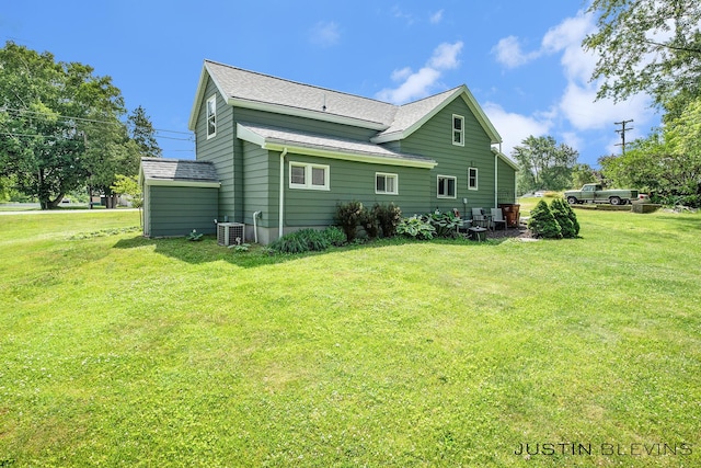 8277 Alpine Ave NW, Sparta, MI 49345 - back of property with a shingled roof and a lawn