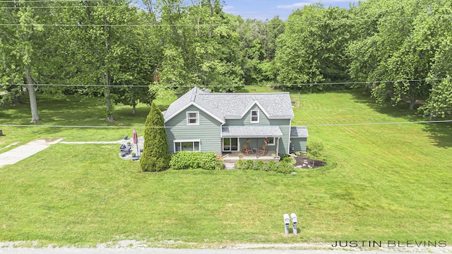8277 Alpine Ave NW, Sparta, MI 49345 - view of front of house with a front lawn and a shingled roof