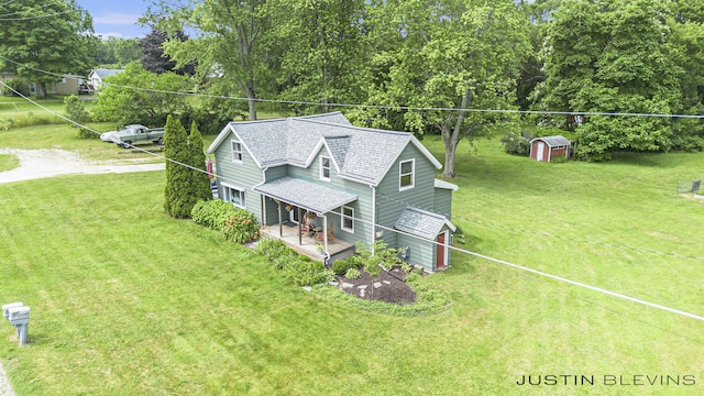 8277 Alpine Ave NW, Sparta, MI 49345 - view of front of property featuring a front lawn, covered porch, a storage unit, and roof with shingles