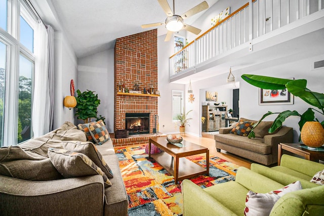 1101 Heritage Dr, Saline, MI 48176 - living room featuring a ceiling fan, high vaulted ceiling, and a brick fireplace