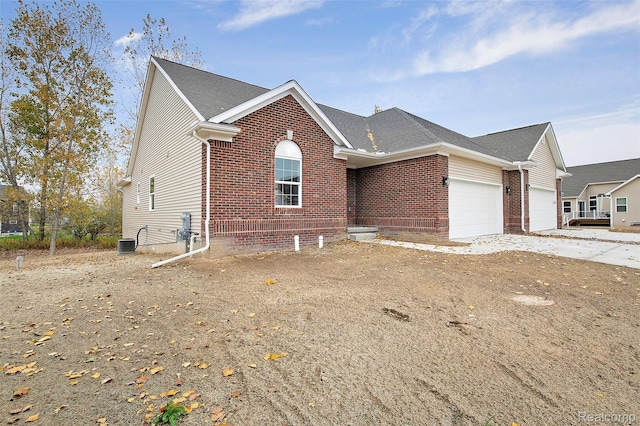 13339 Whispering Pines Ct, Linden, MI 48451 - ranch-style home featuring an attached garage, brick siding, concrete driveway, and roof with shingles