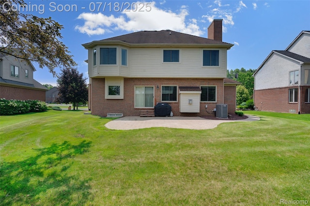 24352 Cavendish Ave W, Novi, MI 48375 - back of property featuring brick siding, a chimney, a patio, and a lawn