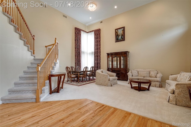 24352 Cavendish Ave W, Novi, MI 48375 - living room with stairway, wood finished floors, and crown molding
