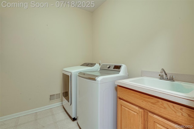 24352 Cavendish Ave W, Novi, MI 48375 - washroom featuring separate washer and dryer, cabinet space, and light flooring