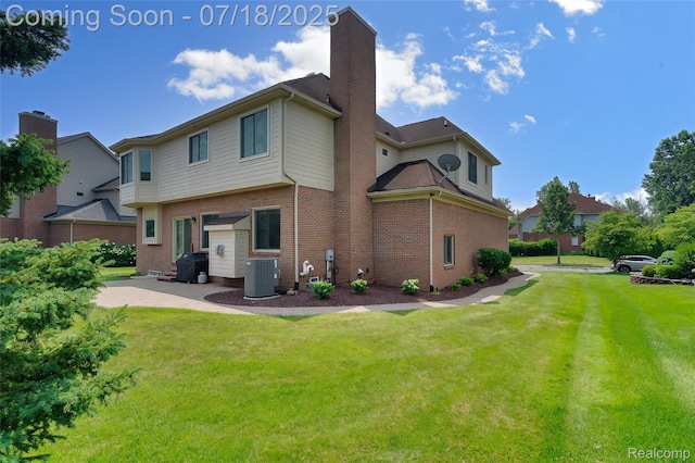 24352 Cavendish Ave W, Novi, MI 48375 - back of property featuring brick siding, a lawn, a chimney, and a patio area