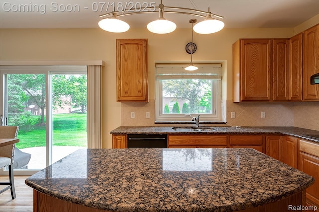 24352 Cavendish Ave W, Novi, MI 48375 - kitchen with plenty of natural light, a kitchen island, and dark stone countertops