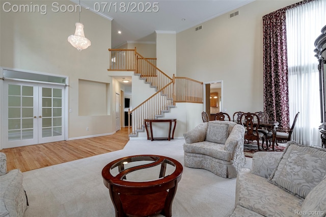 24352 Cavendish Ave W, Novi, MI 48375 - living area featuring crown molding, stairway, a towering ceiling, healthy amount of natural light, and carpet floors