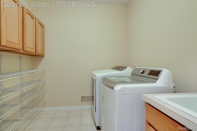 24352 Cavendish Ave W, Novi, MI 48375 - laundry room with cabinet space, washing machine and clothes dryer, and light floors