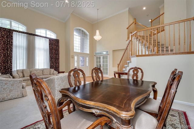 24352 Cavendish Ave W, Novi, MI 48375 - carpeted dining area featuring stairs, a high ceiling, healthy amount of natural light, ornamental molding, and french doors