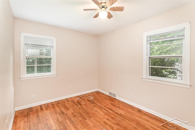 114 E Sugnet Rd, Midland, MI 48642 - empty room featuring plenty of natural light, light wood-type flooring, and a ceiling fan