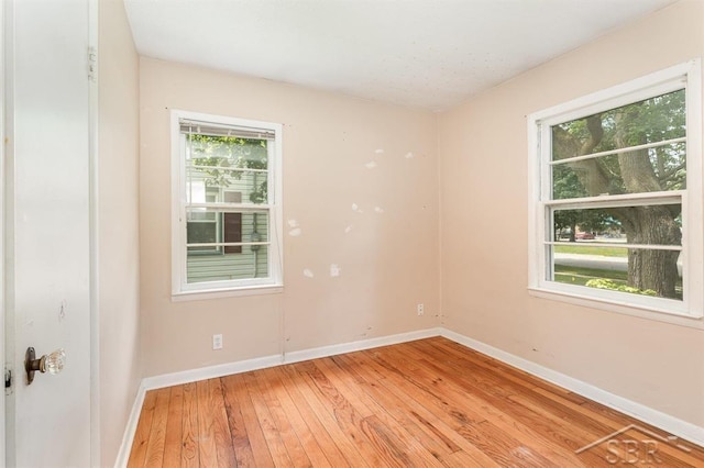 114 E Sugnet Rd, Midland, MI 48642 - empty room with healthy amount of natural light and light wood-style flooring