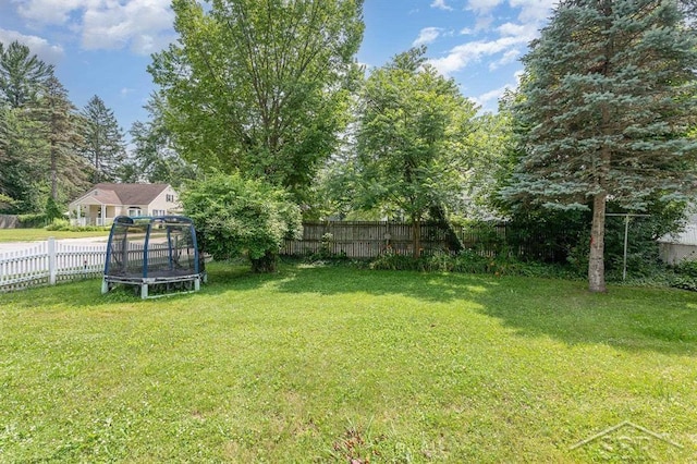 114 E Sugnet Rd, Midland, MI 48642 - fenced backyard featuring a trampoline