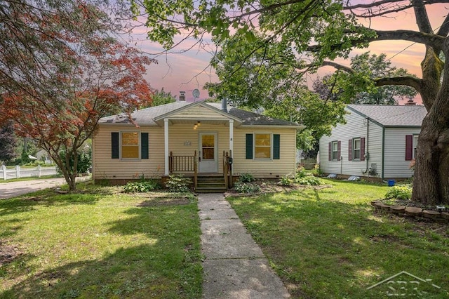 114 E Sugnet Rd, Midland, MI 48642 - bungalow-style house with covered porch and a yard
